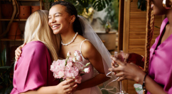 a bride hugging a bridesmaid 