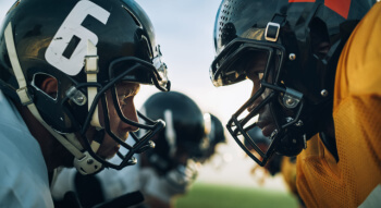 football players touching helmets